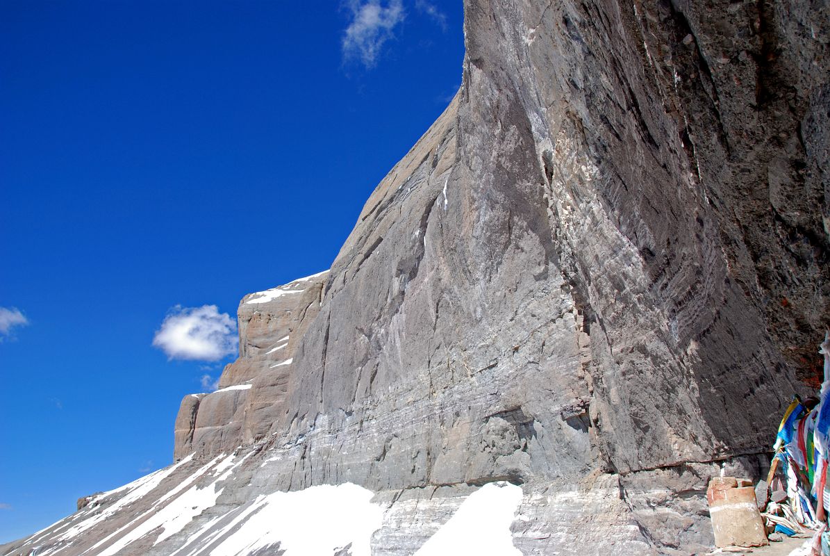 29 Mount Kailash South Face Towers Overhead From The 13 Golden Chortens On Mount Kailash South Face In Saptarishi Cave On Mount Kailash Inner Kora Nandi Parikrama The lower part of the Mount Kailash South Face curves steeply outward, seen from the 13 Golden Chortens on Mount Kailash South Face in Saptarishi Cave. The top of the Atma Linga is just to the right of centre at the bottom of the face.